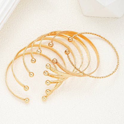 Golden Glow Luxe Bangle Set – 7 Delige Goudkleurige Armbandenset